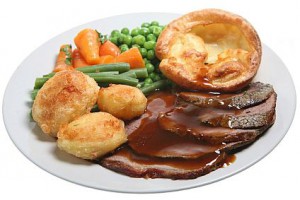 Traditional Sunday roast beef dinner with Yorkshire pudding, roast potatoes and vegetables